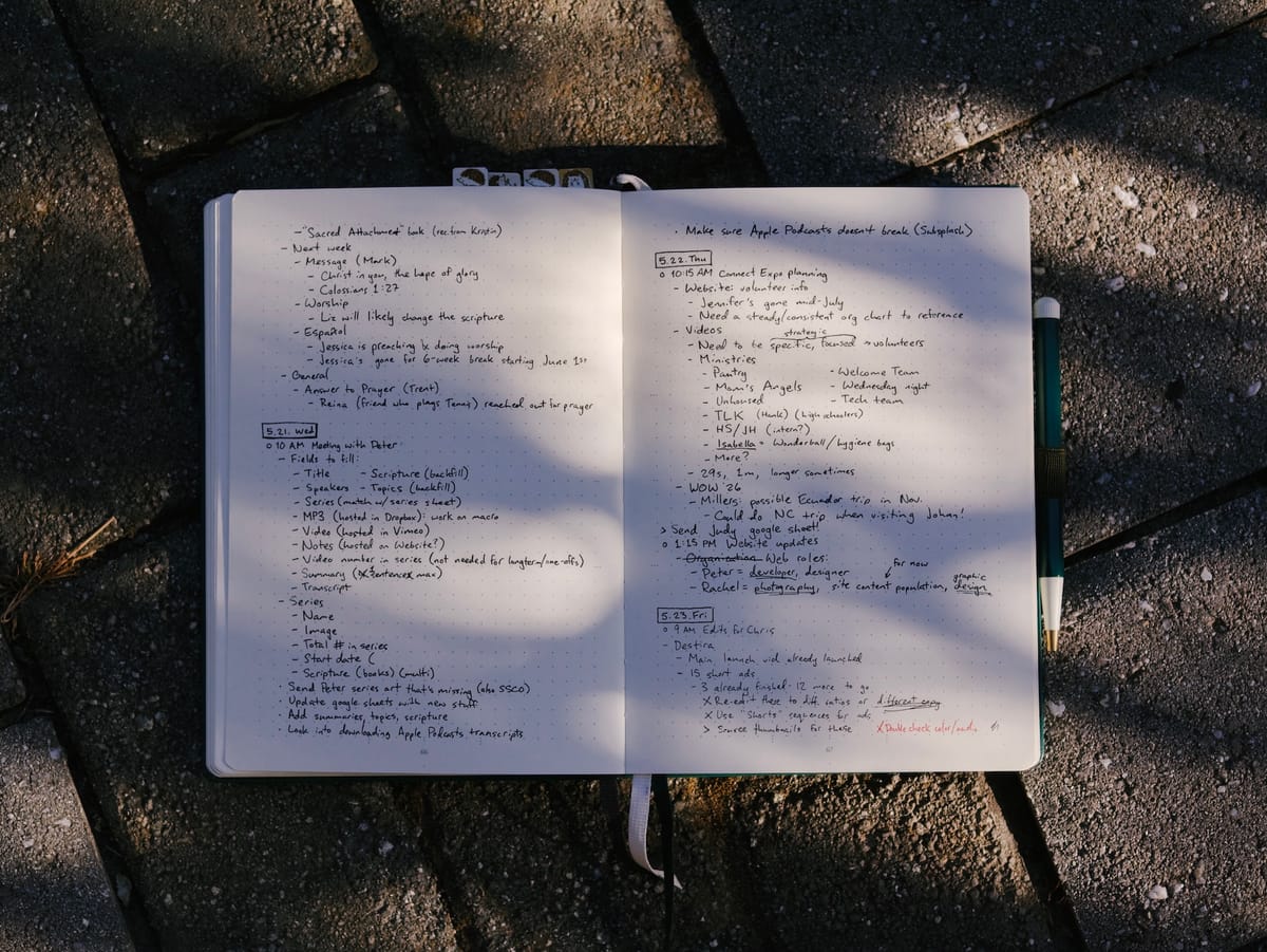 Photo of my bullet journal sitting on a stone path.
